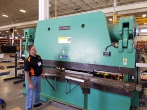 A SFMS team member inspects an accupress machine