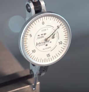 Tap vise to bring indicator to zero on opposite end from pivot point